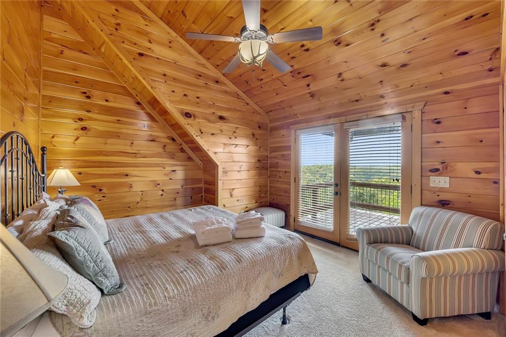 499 Raven Ridge Circle Mineral Bluff, GA 30559 - Photo 17 of 43 a bedroom with a bed couch and a large window