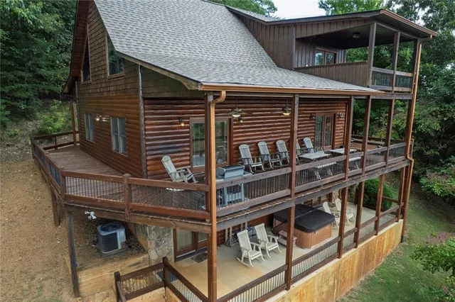 a front view of house with balcony and outdoor seating