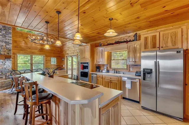 a kitchen with stainless steel appliances granite countertop a sink a stove and refrigerator