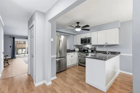 a kitchen with stainless steel appliances granite countertop a refrigerator stove and sink