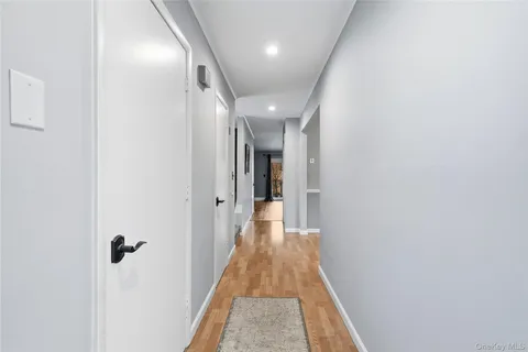 a view of a hallway with wooden floor