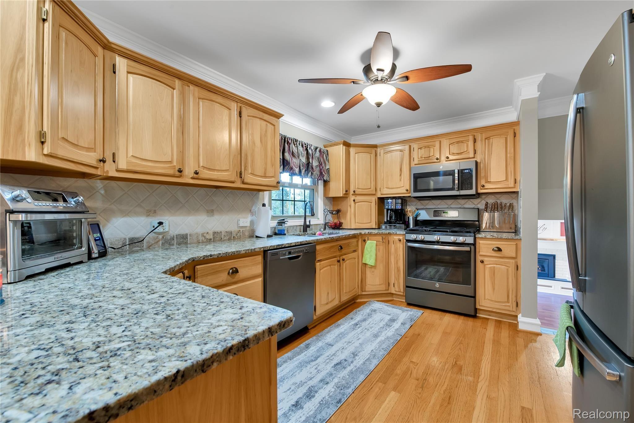 4853 Kidder Road Almont, MI 48003 - Photo 8 of 31 kitchen with newer stainless appliances and granite countertops