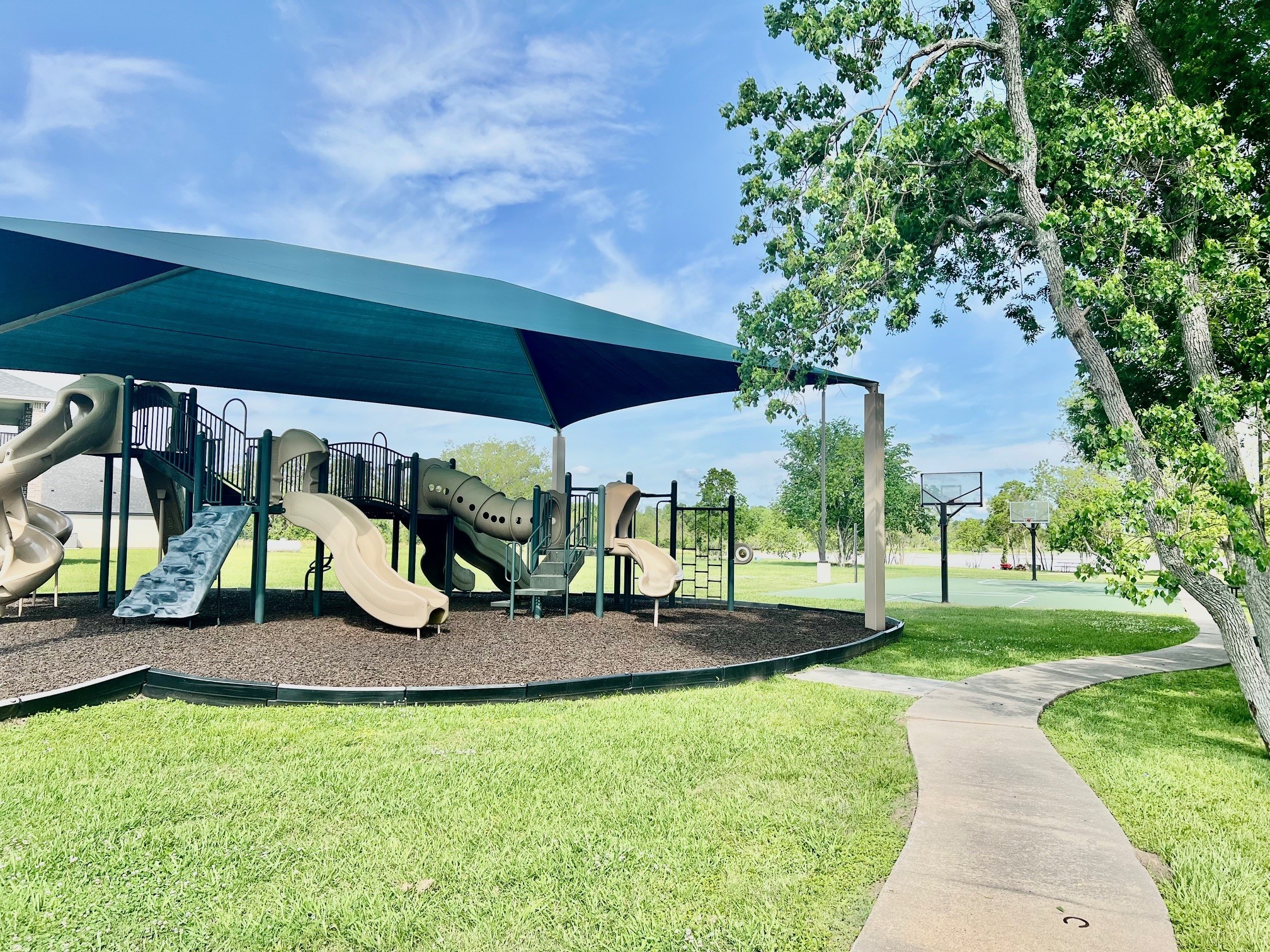443 Lakeview Drive Angleton, TX 77515 - Photo 9 of 12 a view of a park with plants and a bench