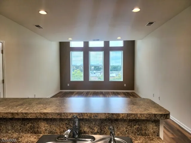 a view of room with window and wooden floor