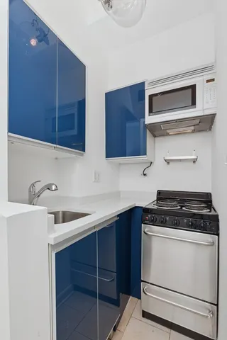 a kitchen with a refrigerator and a sink