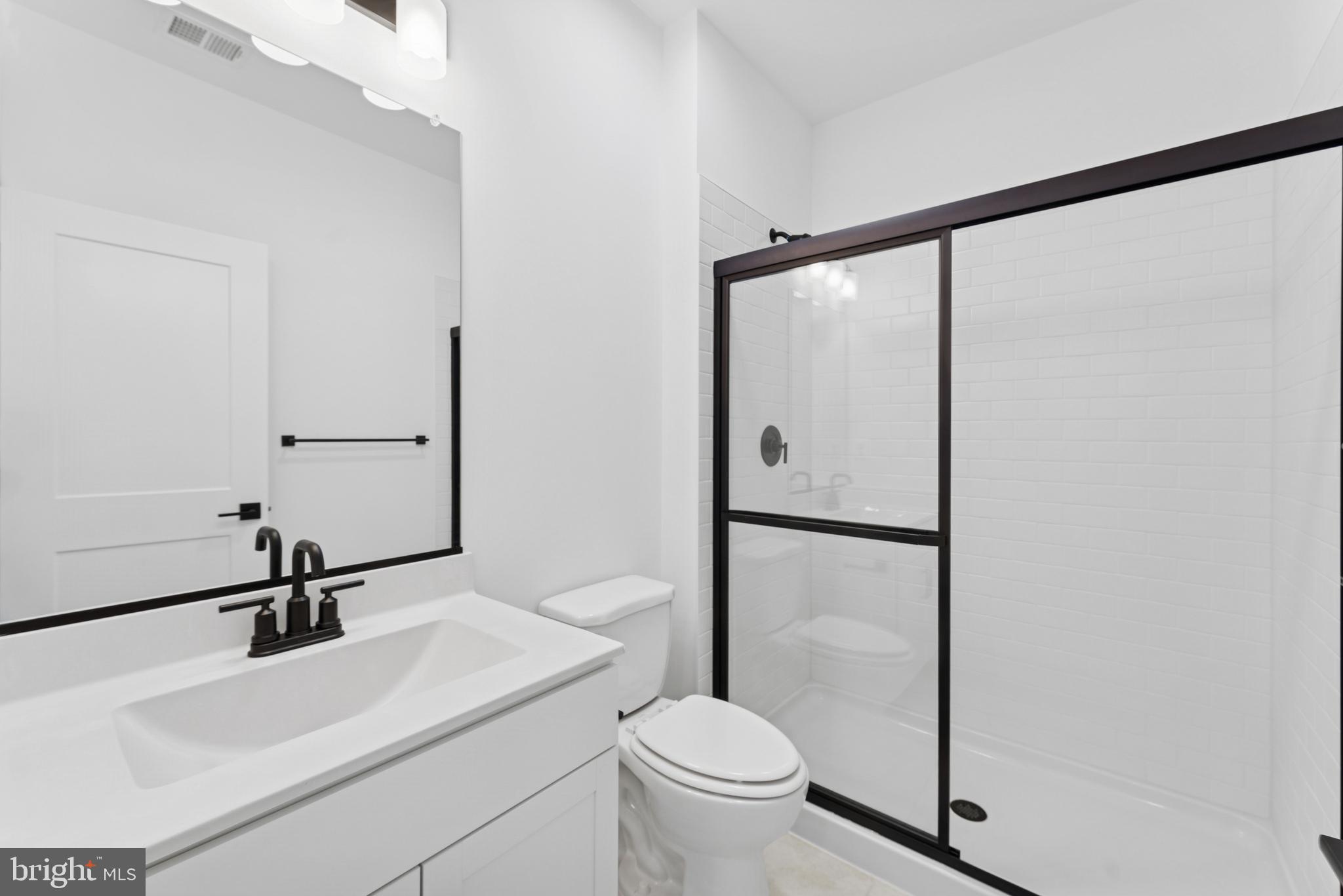94 Thornton Avenue Ranson, WV 25438 - Photo 11 of 22 a bathroom with a sink toilet and a mirror