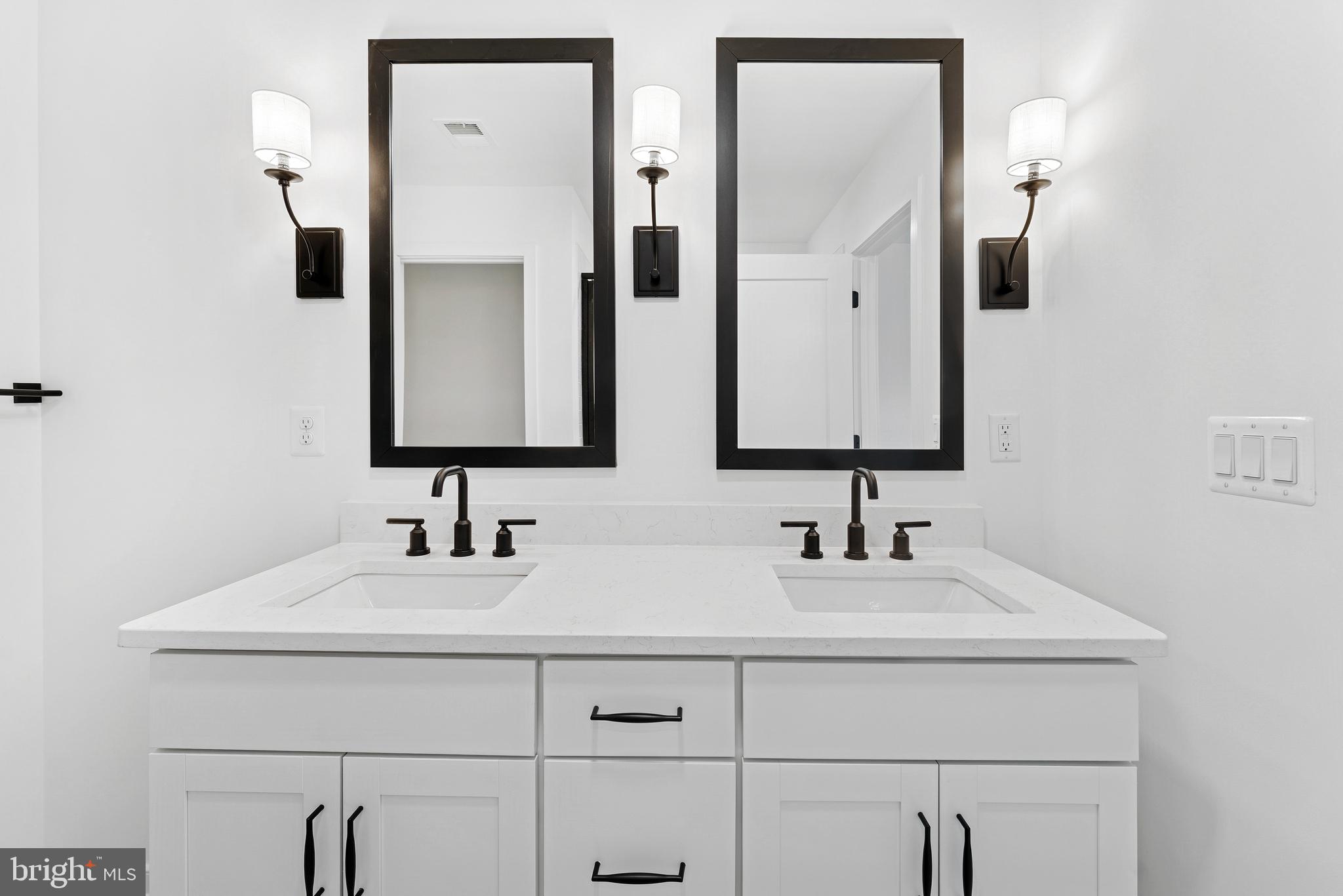 94 Thornton Avenue Ranson, WV 25438 - Photo 20 of 22 a bathroom with double vanity sink and two mirror