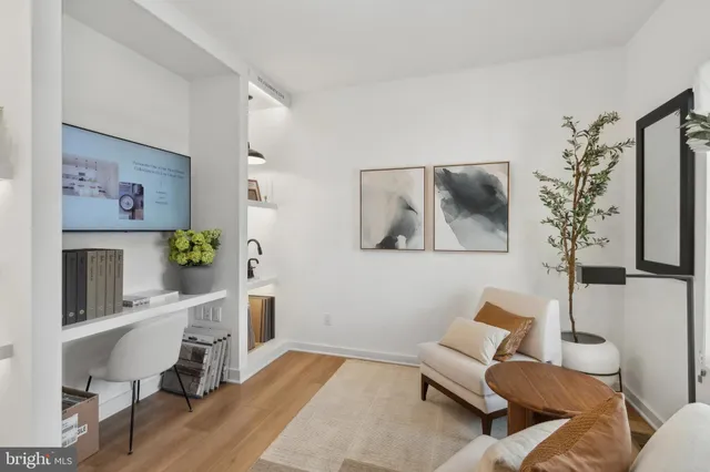 a living room with furniture and a lamp