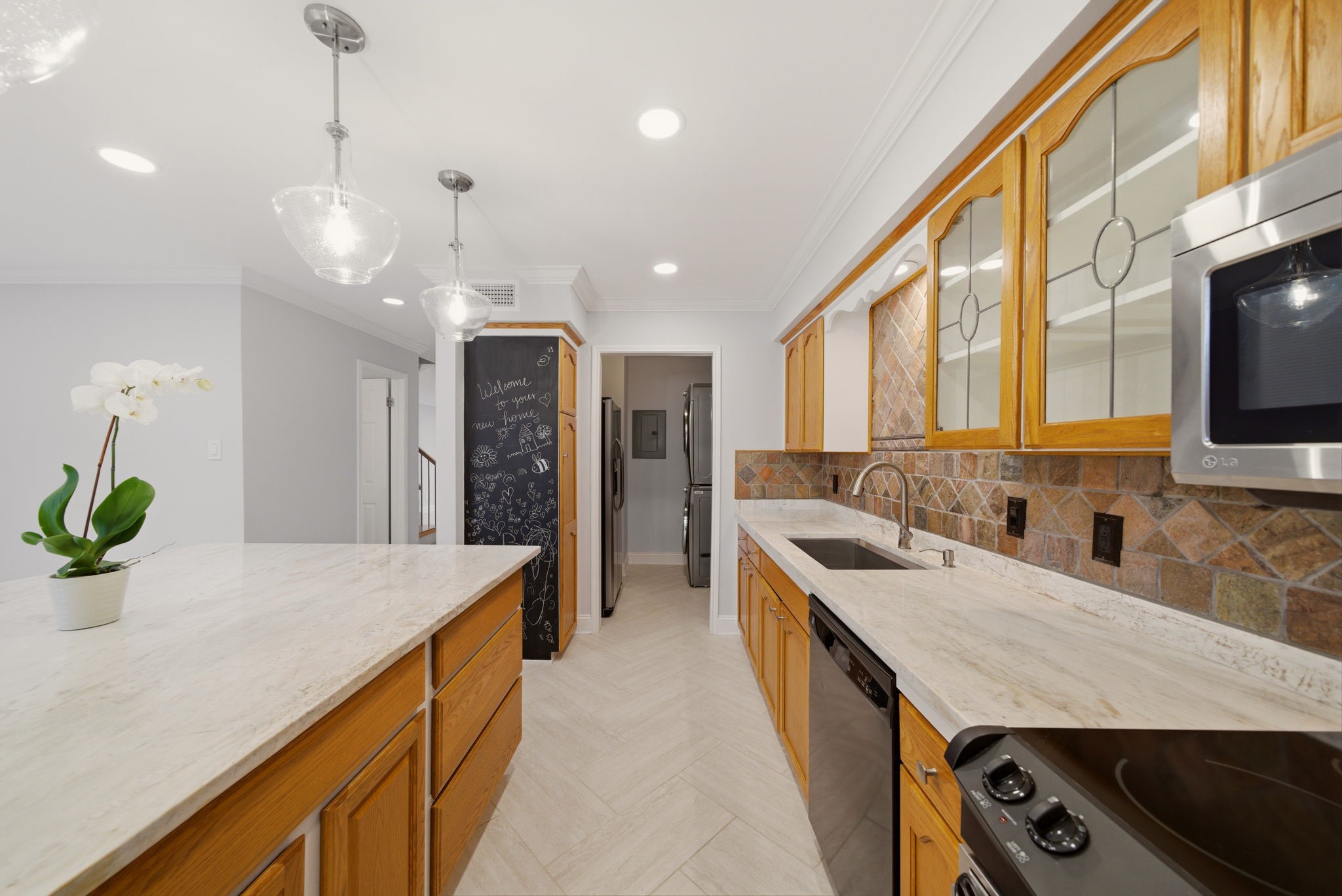 6452 Burgoyne Road, Unit 100 Houston, TX 77057 - Photo 14 of 44 a kitchen with stainless steel appliances granite countertop a sink a stove and a wooden floors
