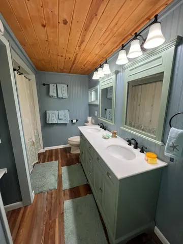a bathroom with a double vanity sink and mirror