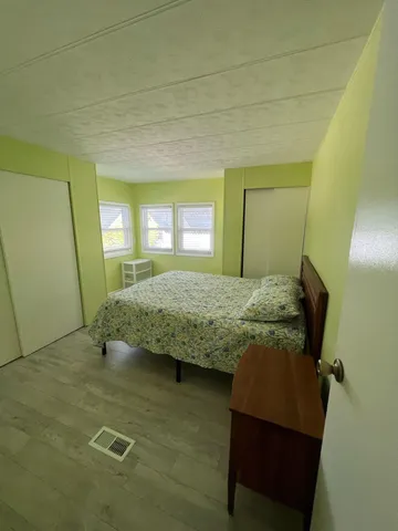 a bedroom with a bed and a mirror