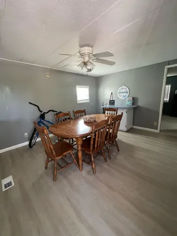 a dining room with furniture a chandelier and wooden floor
