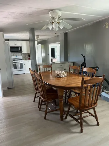 a dining room with a wooden table and chairs