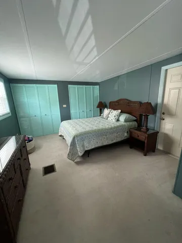 a bedroom with bed and window