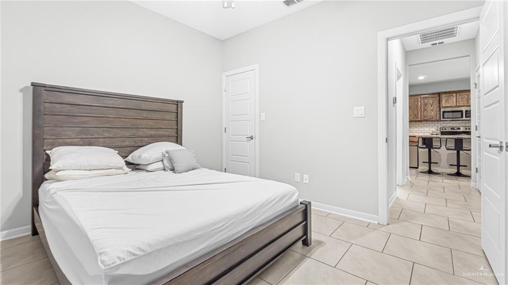 14208 Boykin Creek Road McAllen, TX 78504 - Photo 16 of 30 a bedroom with a bed and a mirror