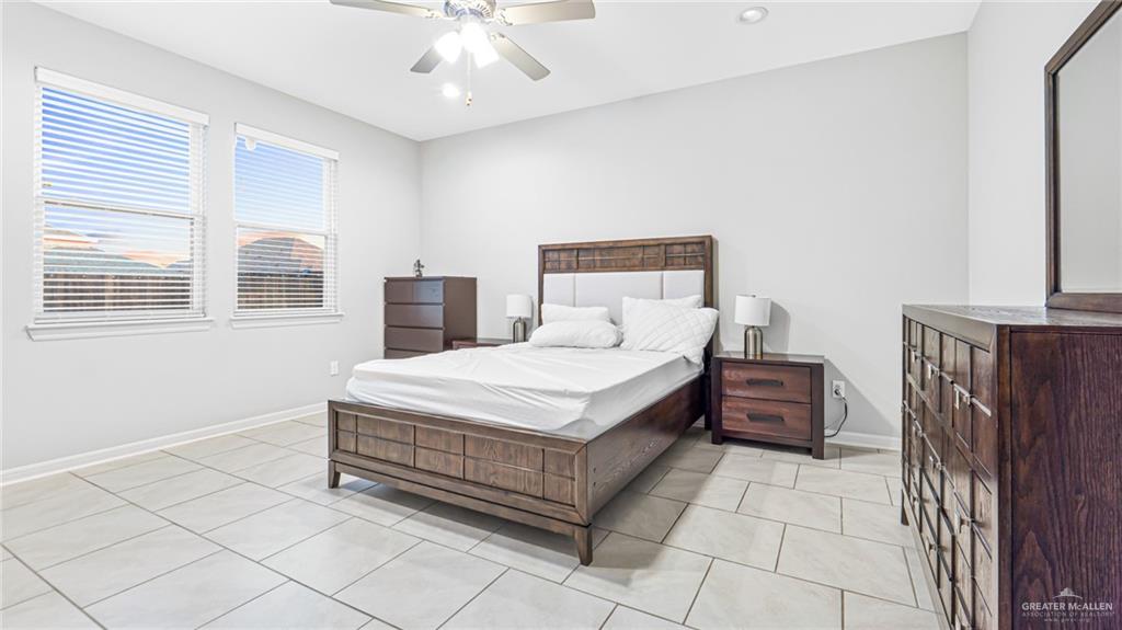 14208 Boykin Creek Road McAllen, TX 78504 - Photo 18 of 30 a bedroom with a large bed and a chandelier