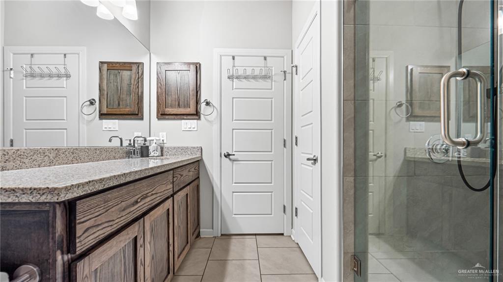 14208 Boykin Creek Road McAllen, TX 78504 - Photo 23 of 30 a bathroom with a granite countertop sink shower and a mirror