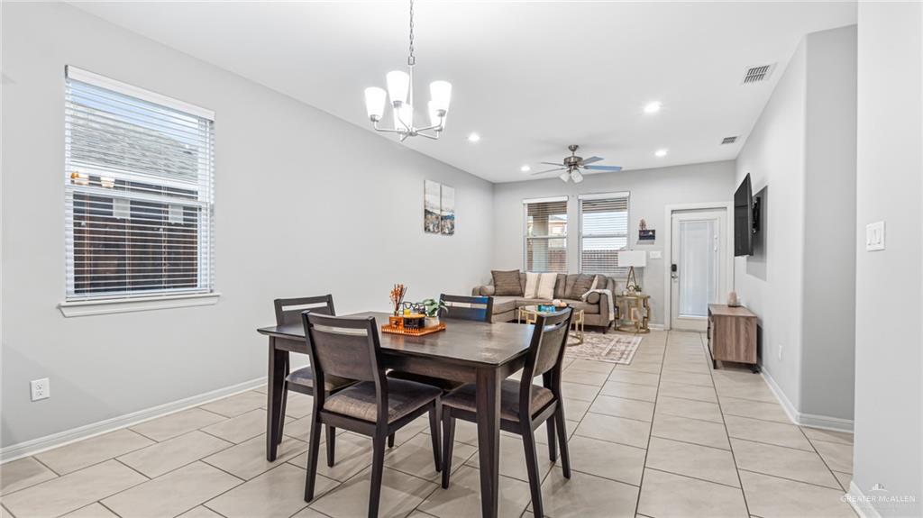 14208 Boykin Creek Road McAllen, TX 78504 - Photo 9 of 30 a view of a dining room with furniture and chandelier