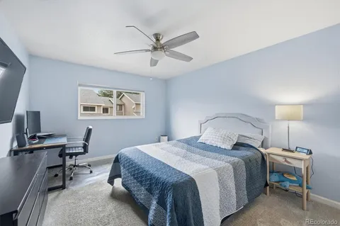 a bedroom with a bed and a desk