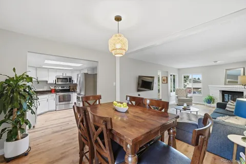 a view of a dining room with furniture wooden floor and chandelier