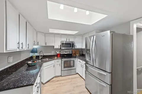 a kitchen with a refrigerator a sink and cabinets