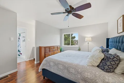 a bedroom with a large bed and a chandelier