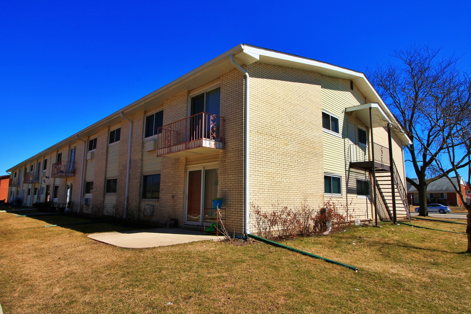 9418 Dee Road, Unit 2B Des Plaines, IL 60016 - Photo 19 of 21 a front view of a house with a yard