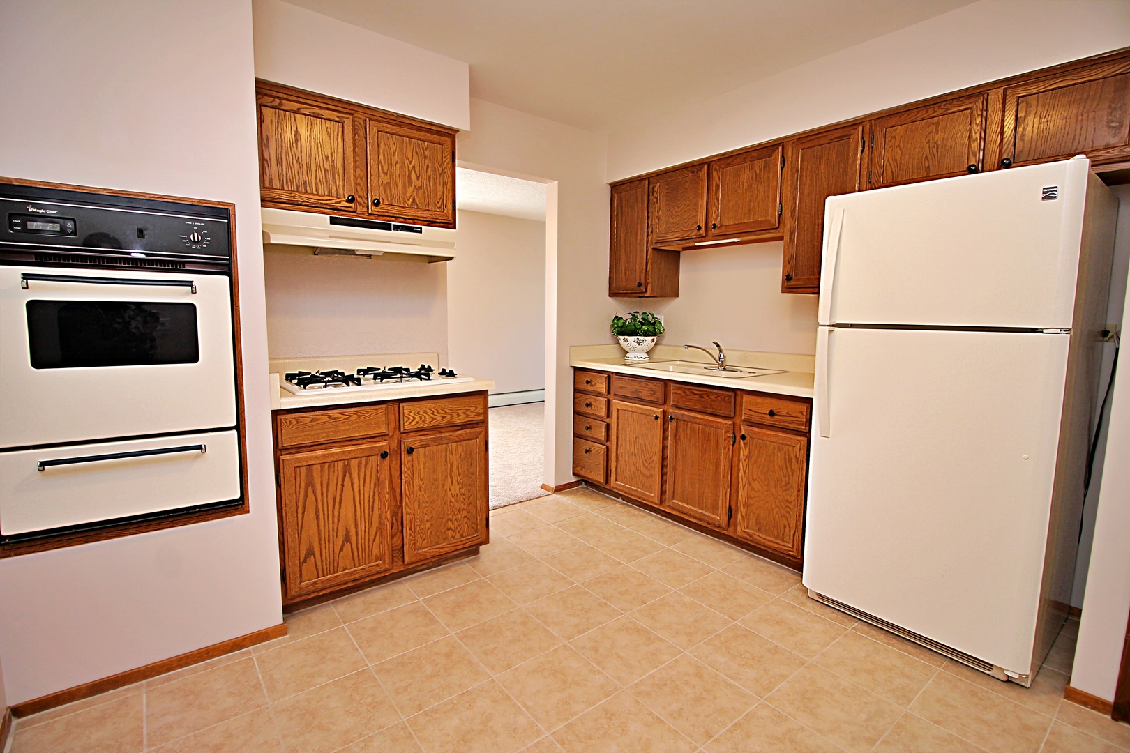 9418 Dee Road, Unit 2B Des Plaines, IL 60016 - Photo 4 of 21 a kitchen with cabinets a refrigerator and a stove
