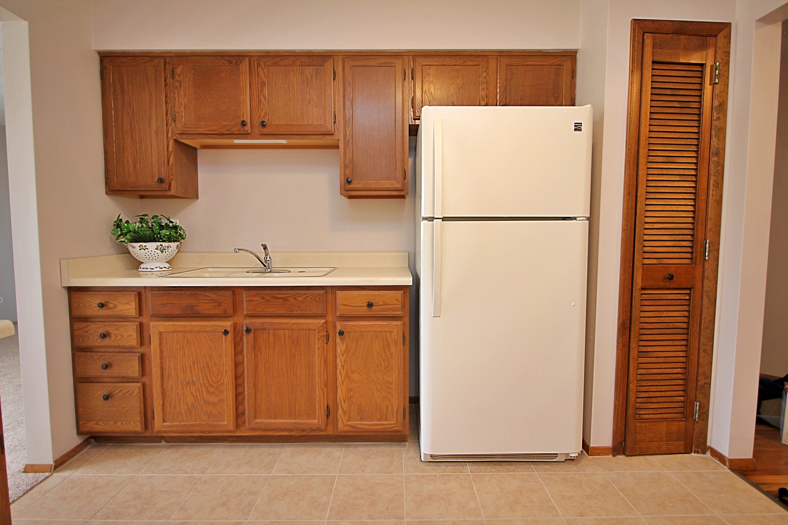 9418 Dee Road, Unit 2B Des Plaines, IL 60016 - Photo 5 of 21 a white refrigerator freezer sitting in a kitchen