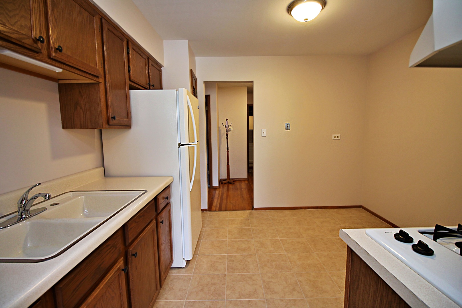 9418 Dee Road, Unit 2B Des Plaines, IL 60016 - Photo 6 of 21 a kitchen with a sink stove and refrigerator
