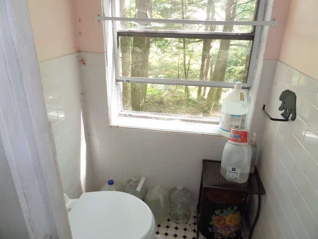155 River Road Worthington, MA 01098 - Photo 12 of 29 a bathroom with a toilet and a shower curtain
