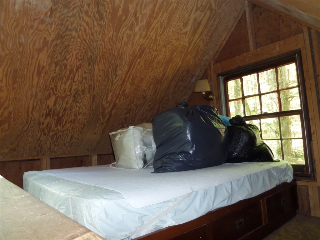 155 River Road Worthington, MA 01098 - Photo 14 of 29 a large bed sitting in a bedroom next to a window