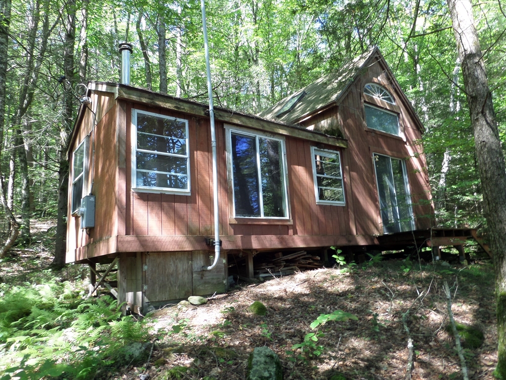 155 River Road Worthington, MA 01098 - Photo 2 of 29 a front view of a house with a yard