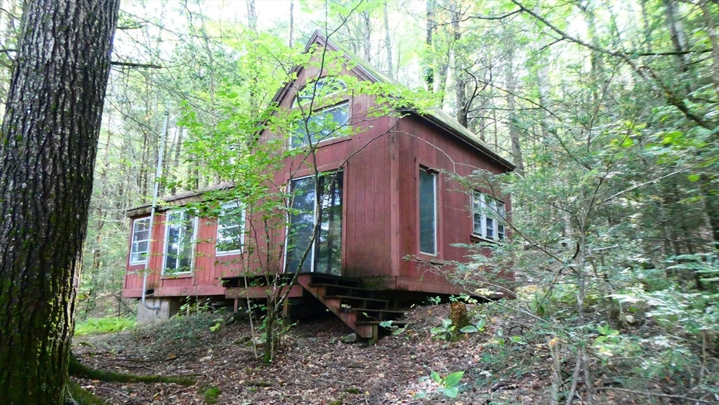 155 River Road Worthington, MA 01098 - Photo 24 of 29 a front view of a house with a yard