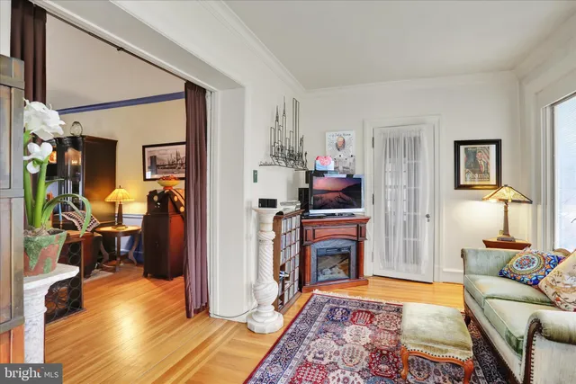 a bedroom with furniture and a wooden floor