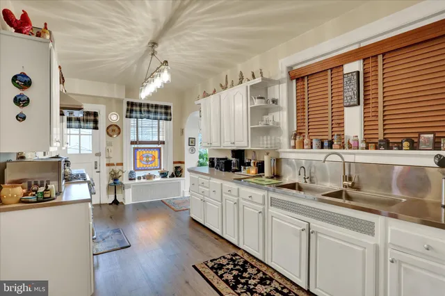 a kitchen with lots of counter top space and wooden floor