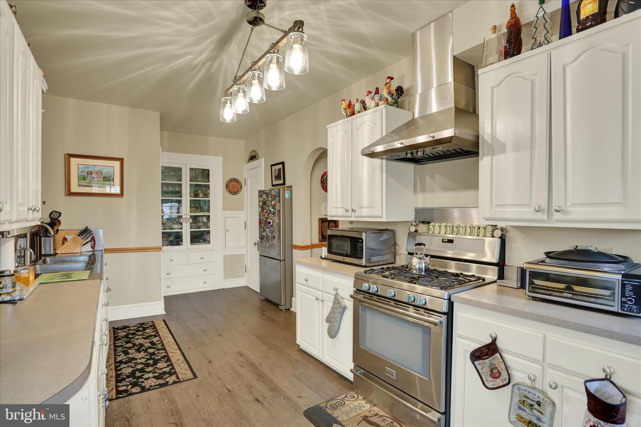 1810 Holly Road Reading, PA 19602 - Photo 19 of 52 a kitchen with stainless steel appliances a stove a sink and a refrigerator