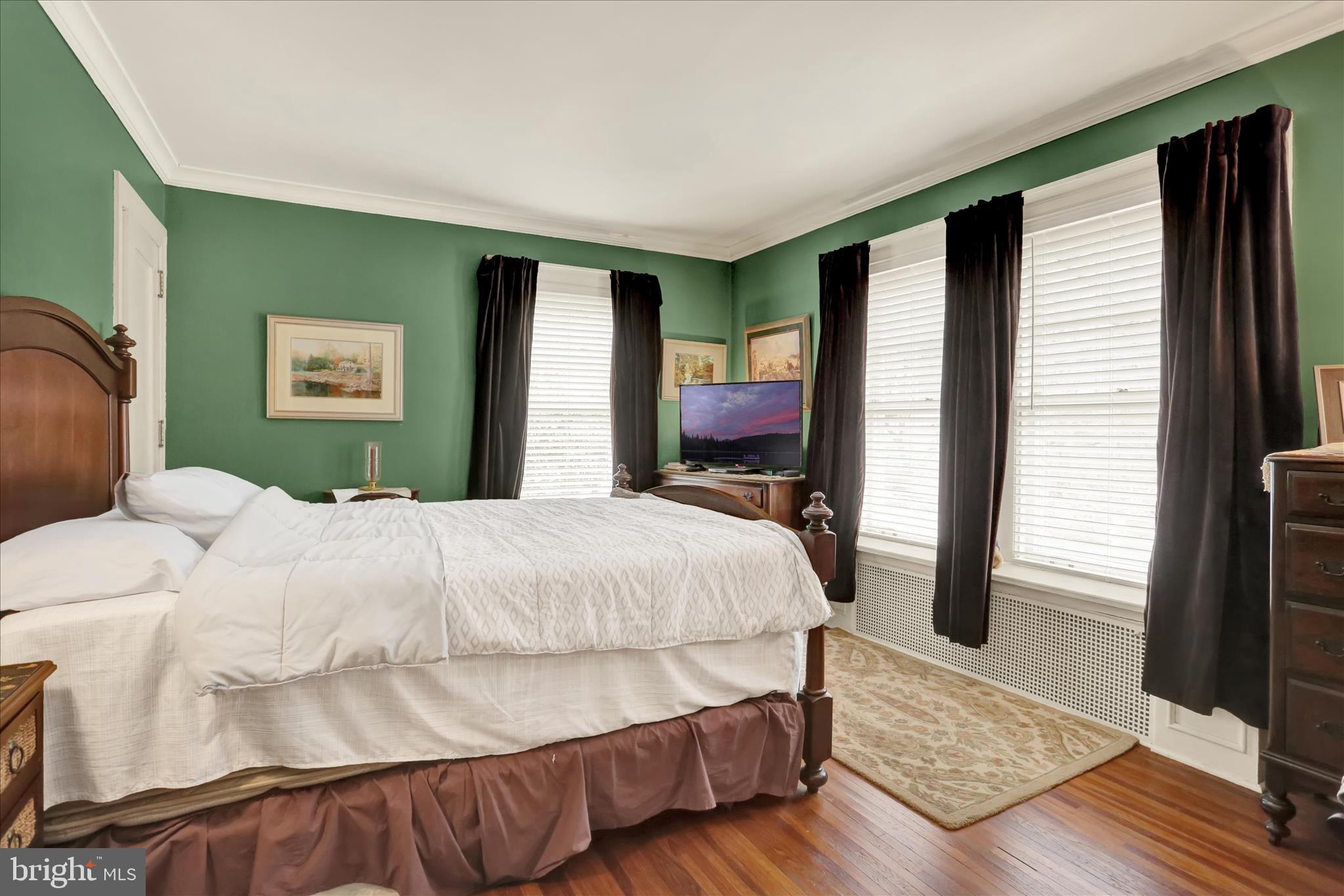 1810 Holly Road Reading, PA 19602 - Photo 32 of 52 a bedroom with a bed and wooden floor