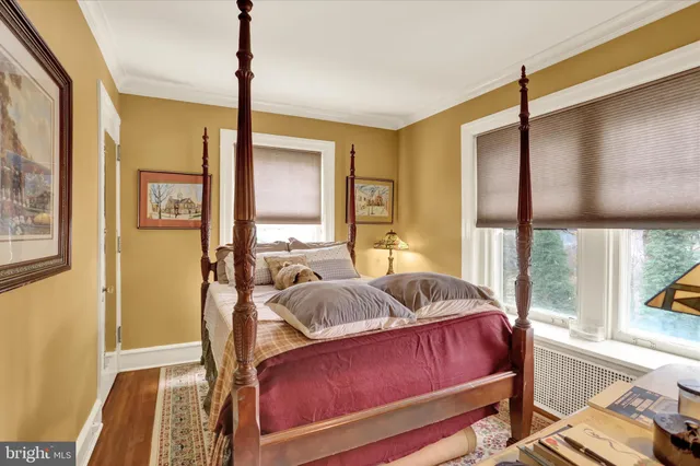 a bedroom with a large bed and a flat screen tv