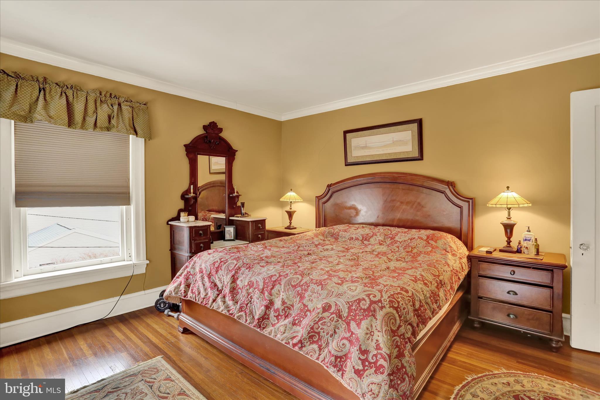1810 Holly Road Reading, PA 19602 - Photo 39 of 52 a bedroom with a bed and wooden floor