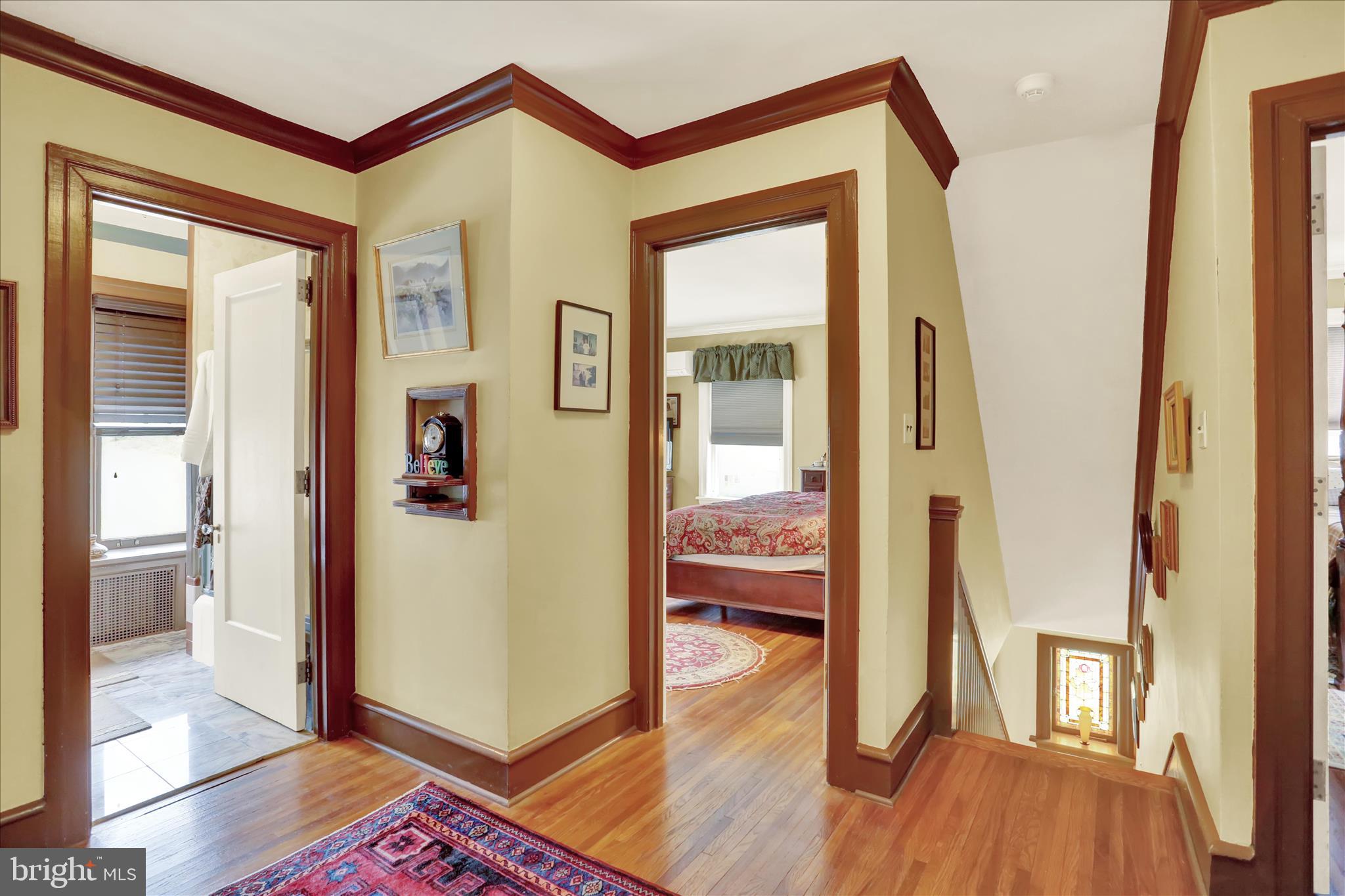 1810 Holly Road Reading, PA 19602 - Photo 41 of 52 a view of a hallway and a livingroom with wooden floor and a bathroom view