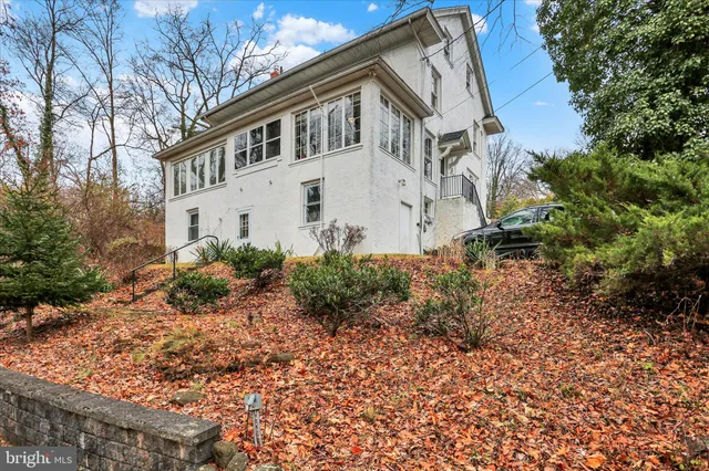a view of a white house with a yard