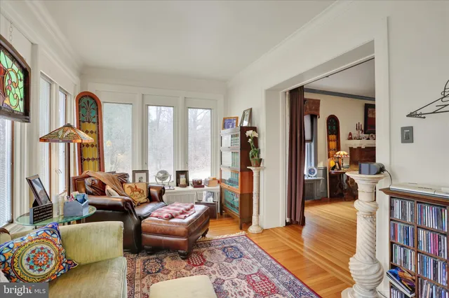 a living room with furniture and a book shelf