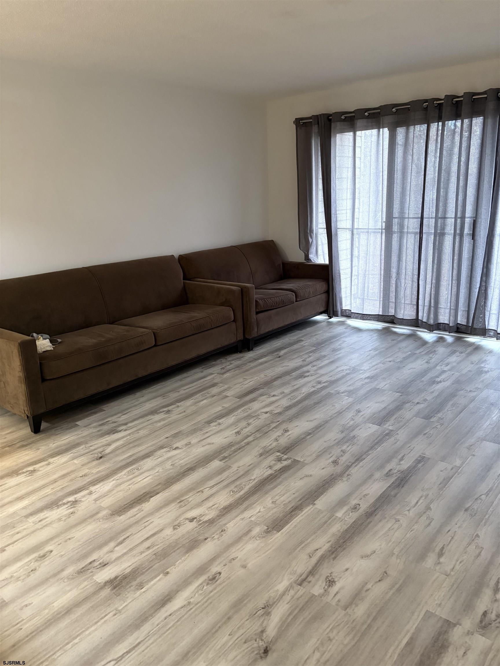 113 Federal, Unit 113 Galloway Township, NJ 08205 - Photo 2 of 13 a living room with furniture and large windows