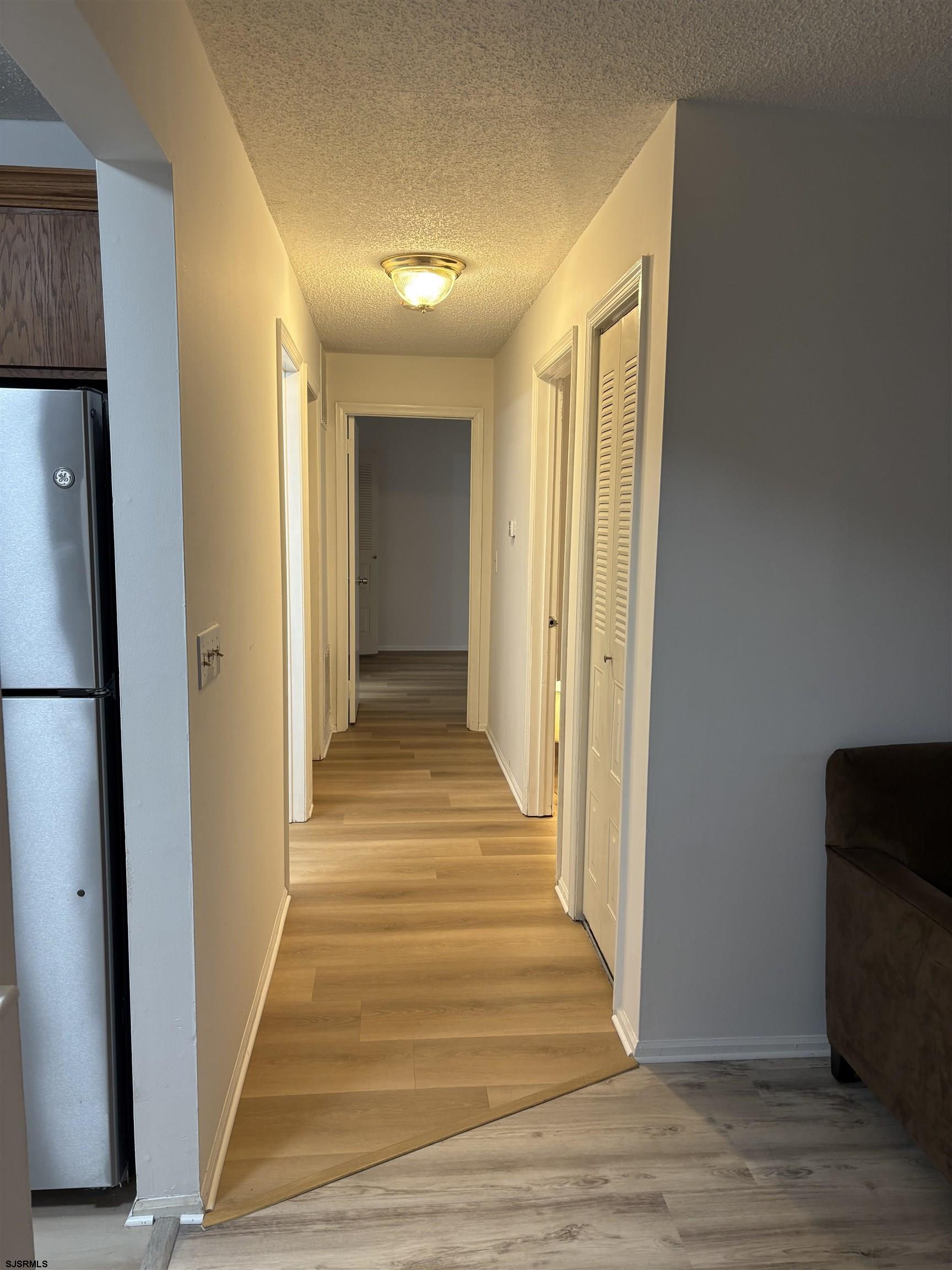 113 Federal, Unit 113 Galloway Township, NJ 08205 - Photo 7 of 13 a view of a hallway with wooden floor and staircase