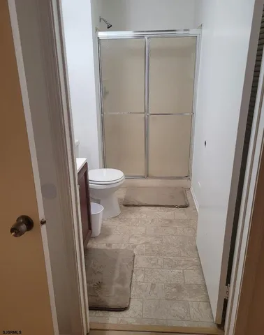 a bathroom with a toilet and a shower