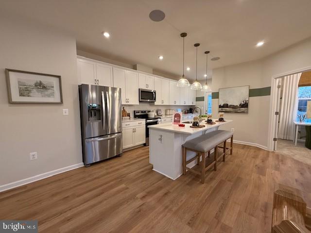10150 Queens Way Manassas, VA 20110 - Photo 19 of 77 a kitchen with a refrigerator a microwave oven a sink a dining table and chairs