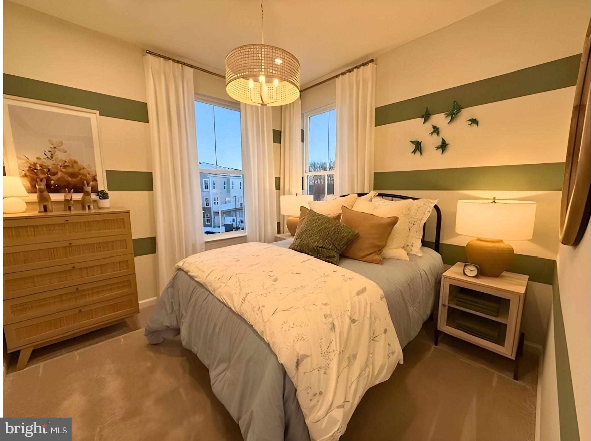 10150 Queens Way Manassas, VA 20110 - Photo 39 of 77 a spacious bedroom with a bed a dresser and a chandelier