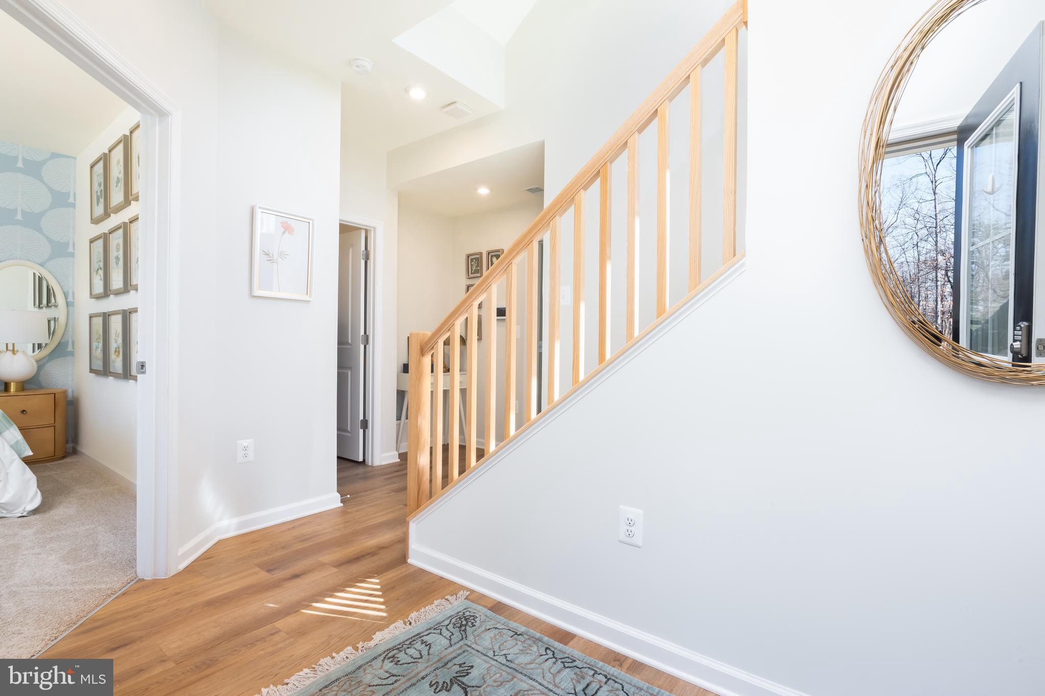 10150 Queens Way Manassas, VA 20110 - Photo 9 of 77 a view of staircase with lots of frames on wall and a large window