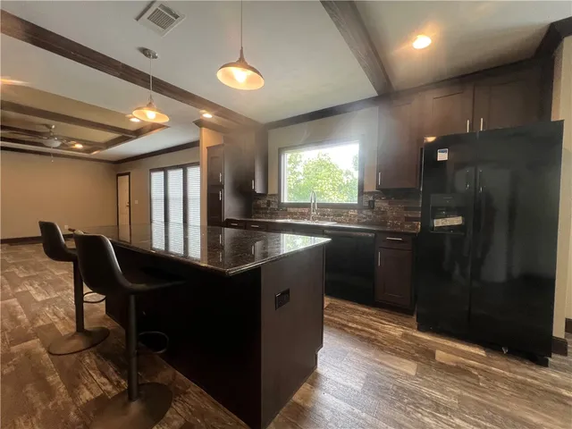 a kitchen with granite countertop sink cabinets and stainless steel appliances